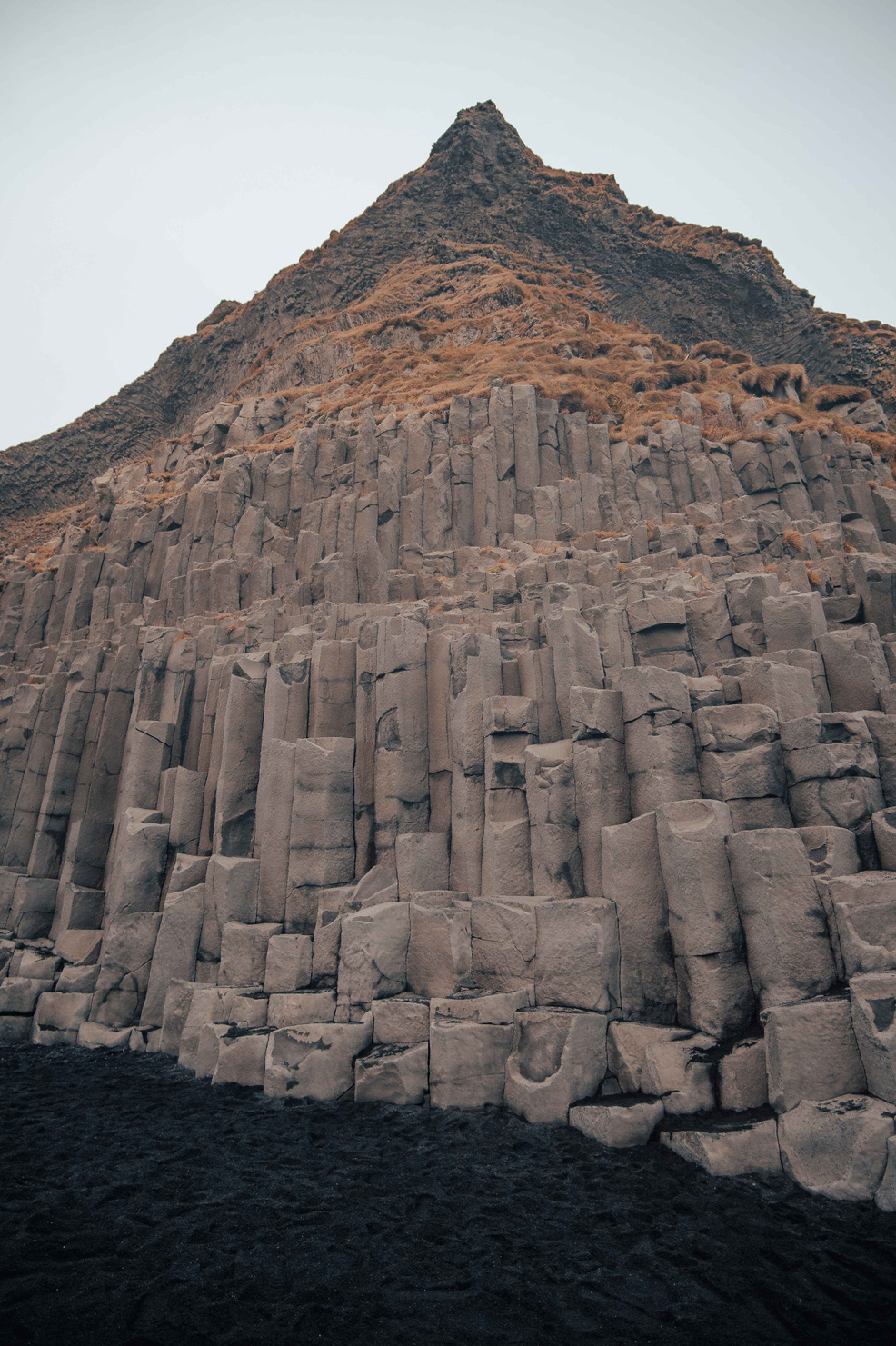 Basalt Formations Reynisfjara beach reveals enchanting basalt formations, formed by nature's artistic touch, amidst the roaring waves.