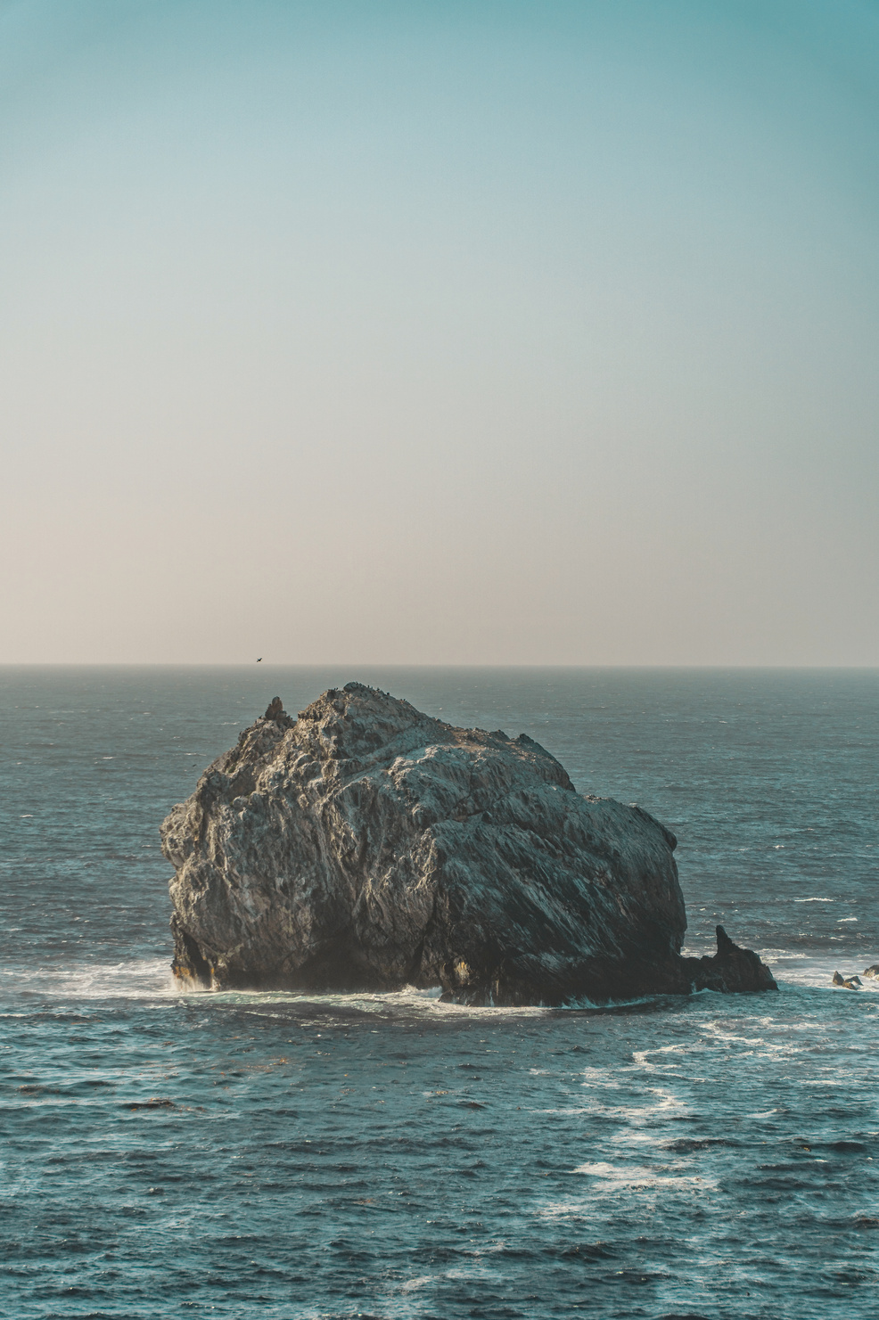 Boulder in the Ocean A photo of a lone boulder crowded with seagulls near Jade Cove, California