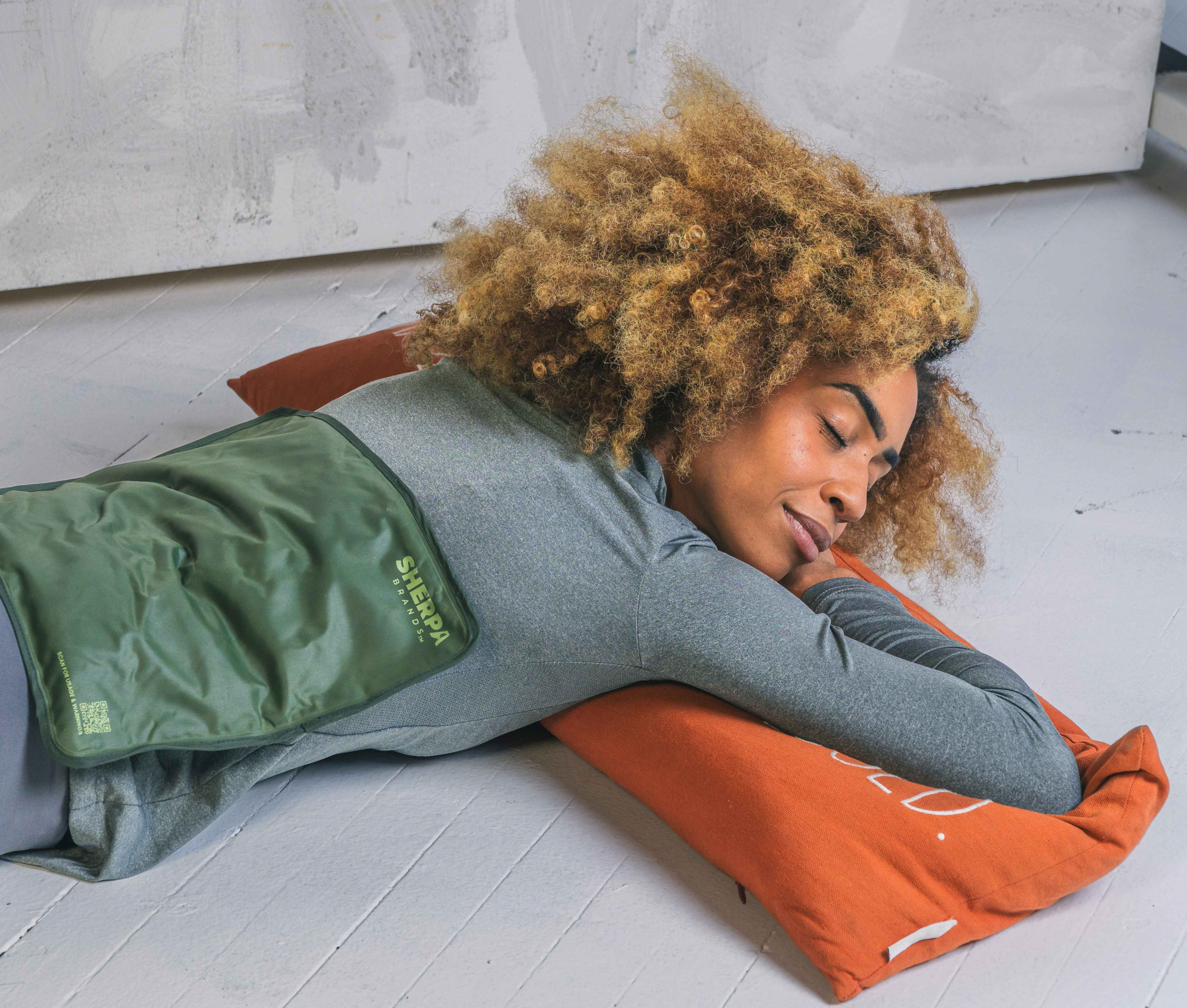 Ice Pack for Pain Woman lying on her stomach with an icepack placed on her upper back, promoting relief and comfort.